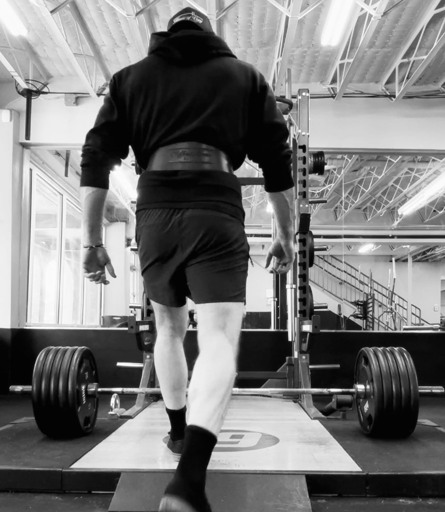 Maverick Strength Co. client in gym with branded apparel