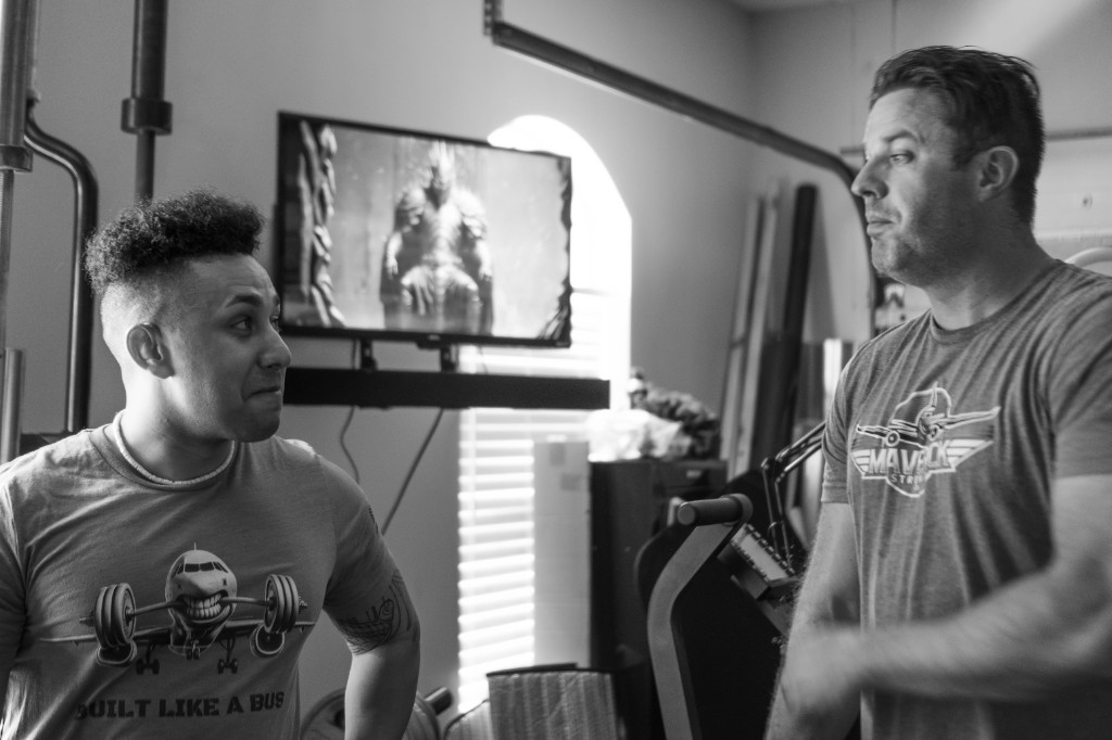 Coach Marc and client in home gym with Maverick branding