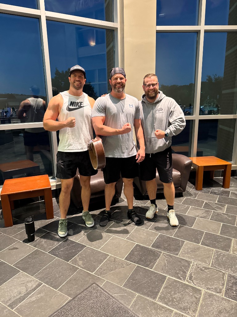 Maverick Strength Co. clients Tom and Matt celebrating together at the gym